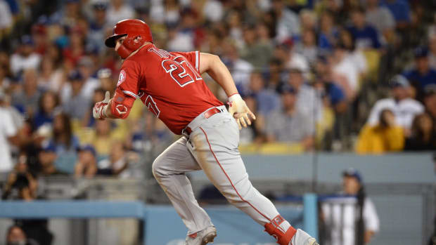 July 24, 2019; Los Angeles, CA, USA; Los Angeles Angels center fielder Mike Trout (27) hits a sacrifice RBI against the Los Angeles Dodgers during the sixth inning at Dodger Stadium. Mandatory Credit: Gary A. Vasquez-USA TODAY Sports